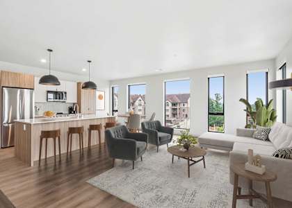 A modern kitchen with a dining area and a living room.