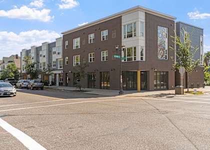 an apartment building on the corner of a city street