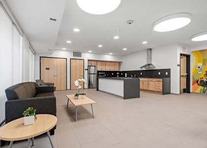 a living area with a kitchen and a table