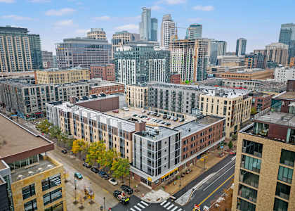 an aerial view of a city with buildings and skyscrapers