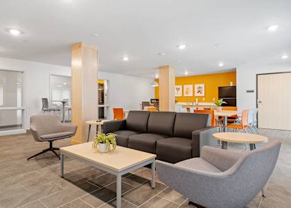 a living room and dining room with couches and chairs
