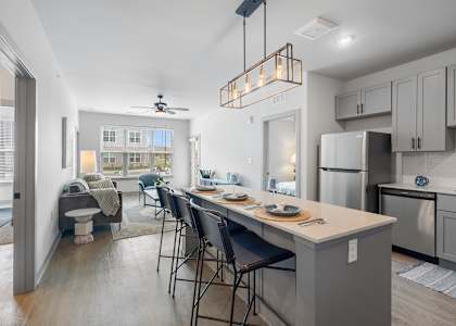 A kitchen with a table and chairs in the middle of the room.