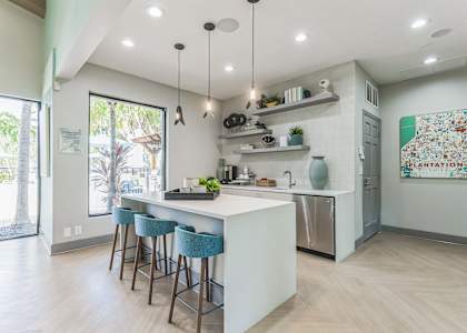 a kitchen with an island and stools in front of a white counter top
