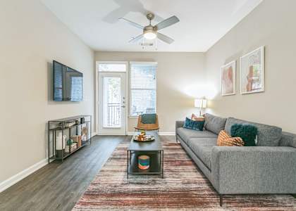 a living room with a couch and a ceiling fan