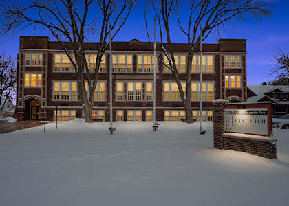 A sign in front of a building that says East High.