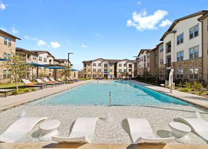 a swimming pool with apartments in the background