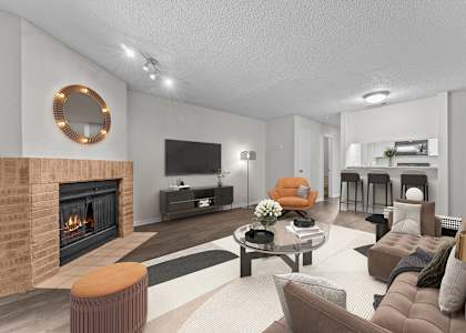 A modern living room with a fireplace and a television.