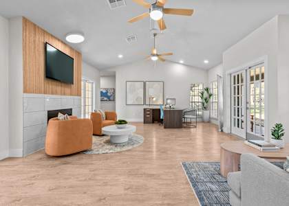 A living room with a television, a fireplace, and a ceiling fan.