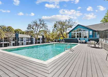 a swimming pool with a house in the background