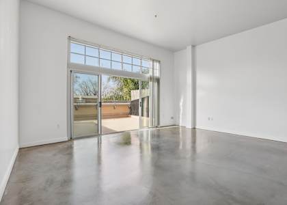 A large empty room with a sliding glass door.