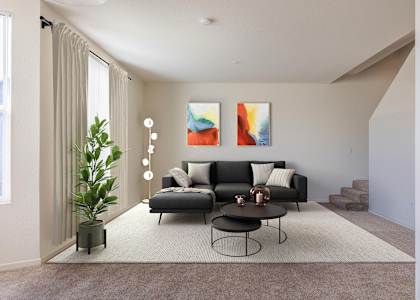 A living room with a black couch, a small table, and a painting on the wall at The Woods Apartments, California, 95136
