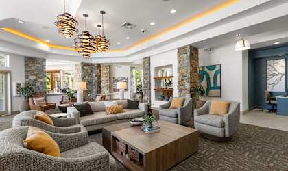 a living room with couches and chairs and a coffee table