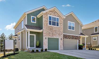A modern two-story house with a garage and a driveway.