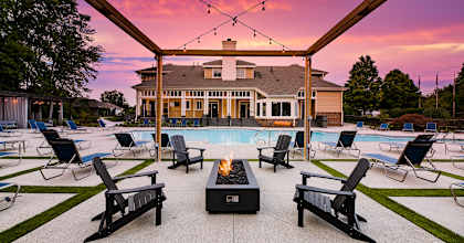 swimming pool with clubhouse in the background at sunset at Butternut Ridge, North Olmsted, Ohio