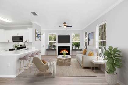 a living room with white walls and a white couch with a coffee table in front of it at Northlake Park, Orlando