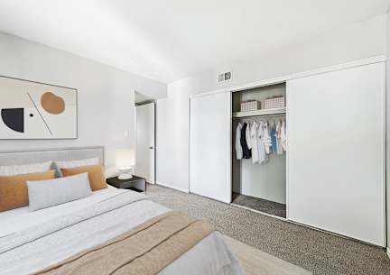Bedroom with wooden dresser at Sycamore Square Apartments, Mesa