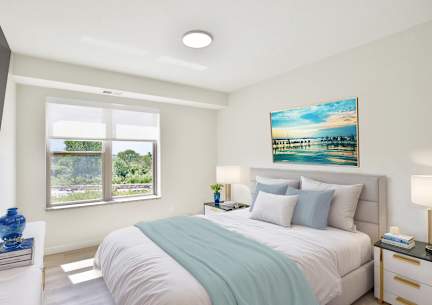 A bedroom with a large bed and a painting on the wall.