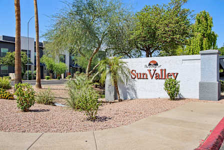 community sign with red letter at The Village at Sun Valley Apartments, Mesa, 85207