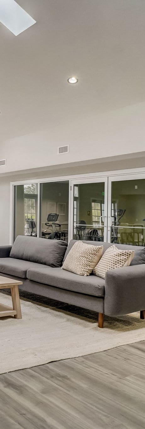 a living room filled with furniture and a large window