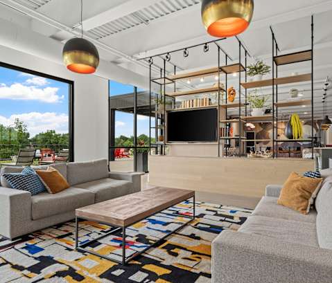 A modern living room with a grey sofa and a wooden coffee table.