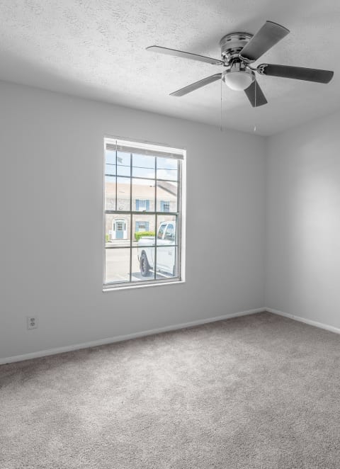 a kitchen with white cabinets and a black dishwasher at Jacksonville Heights Apartments