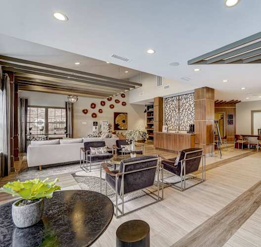 a living room with a couch and a table with chairs