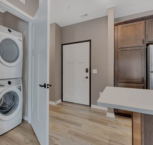 A white washer and dryer are in a small laundry room.