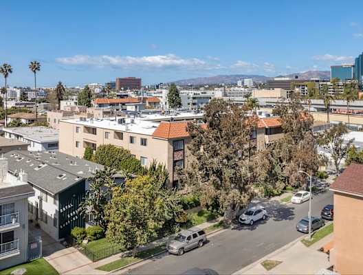 A view of a residential area with houses and cars.