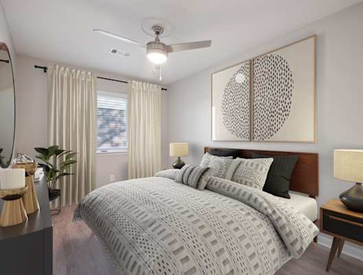 A bedroom with a large bed, a ceiling fan, and a large artwork on the wall.