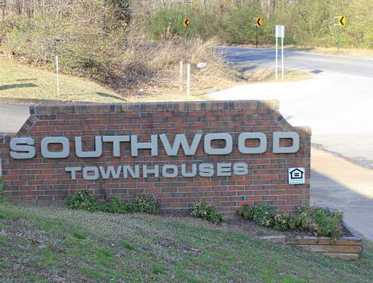 a brick sign for southwood townhouse on the side of a road
