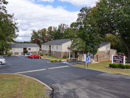 a parking lot in front of a row of houses
