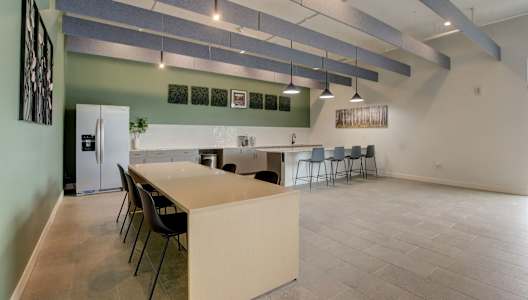 a kitchen and dining room with a long table and chairs