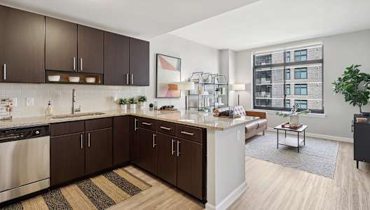 an open kitchen and living room with a large window
