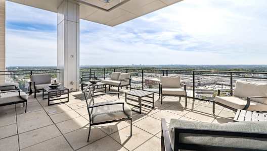 outdoor sitting area with patio furniture and a view of the city
