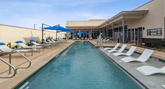 A long rectangular pool with white chairs on the side, Ironcrest,North Richland Hills, TX, 76180