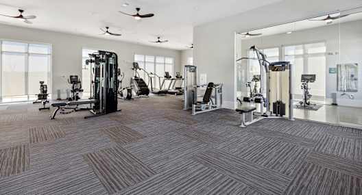 A spacious gym with a variety of equipment and a ceiling fan, Ironcrest, North Richland Hills, TX, 76180