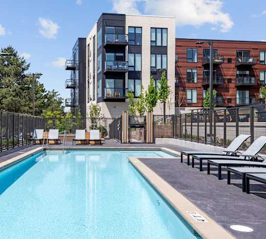 A swimming pool in front of a modern building.