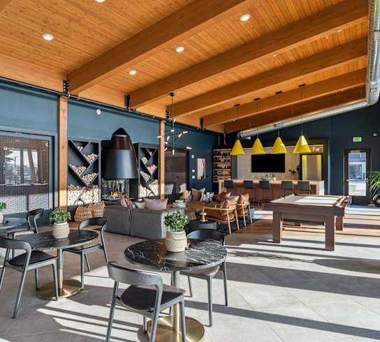 A modern cafe with wooden tables and chairs.