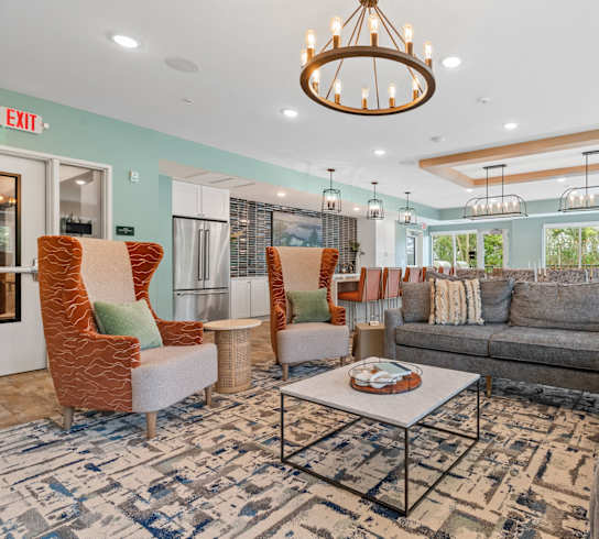 a living room with couches and chairs and a table