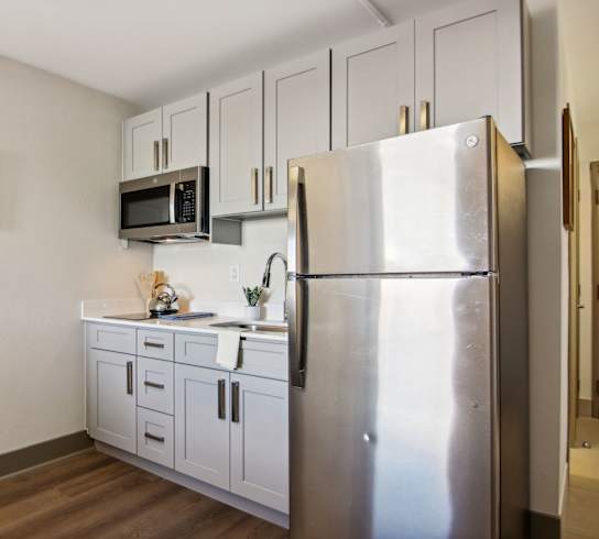 a kitchen with stainless steel appliances and white cabinets