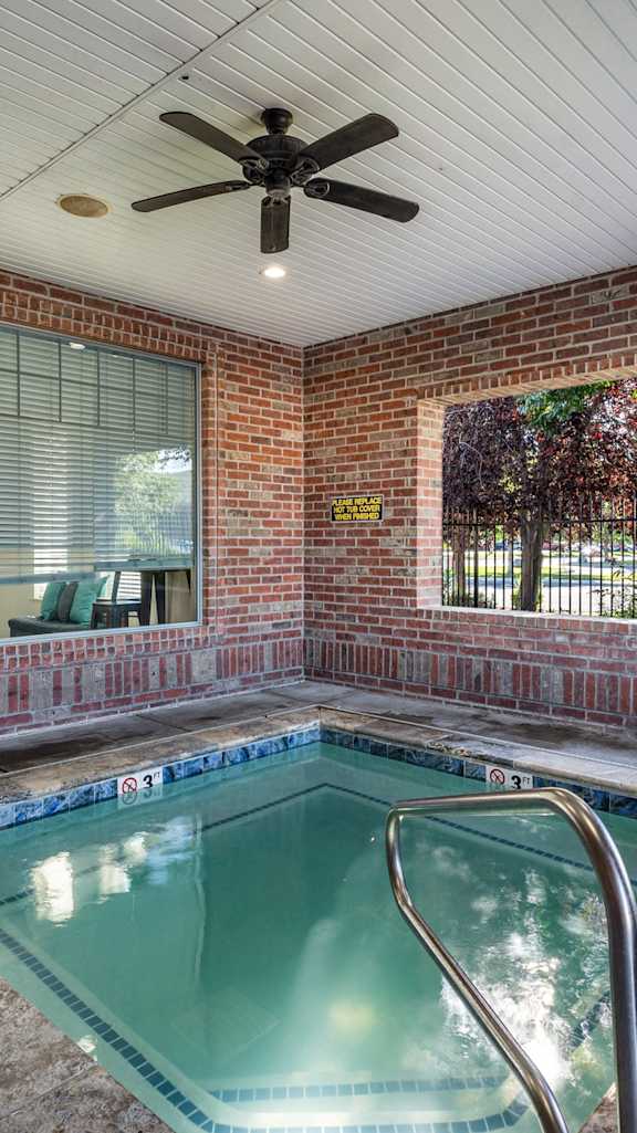 the indoor spa with brick walls and a ceiling fan at Eagles Landing, Ammon, ID