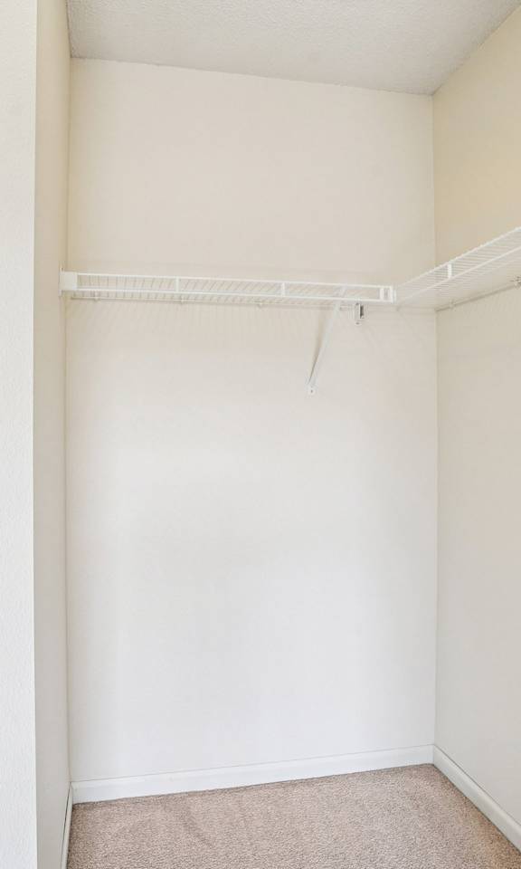 A white wall with a white shelf on top.
