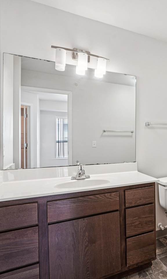 A white bathroom with a sink, toilet, and tub.