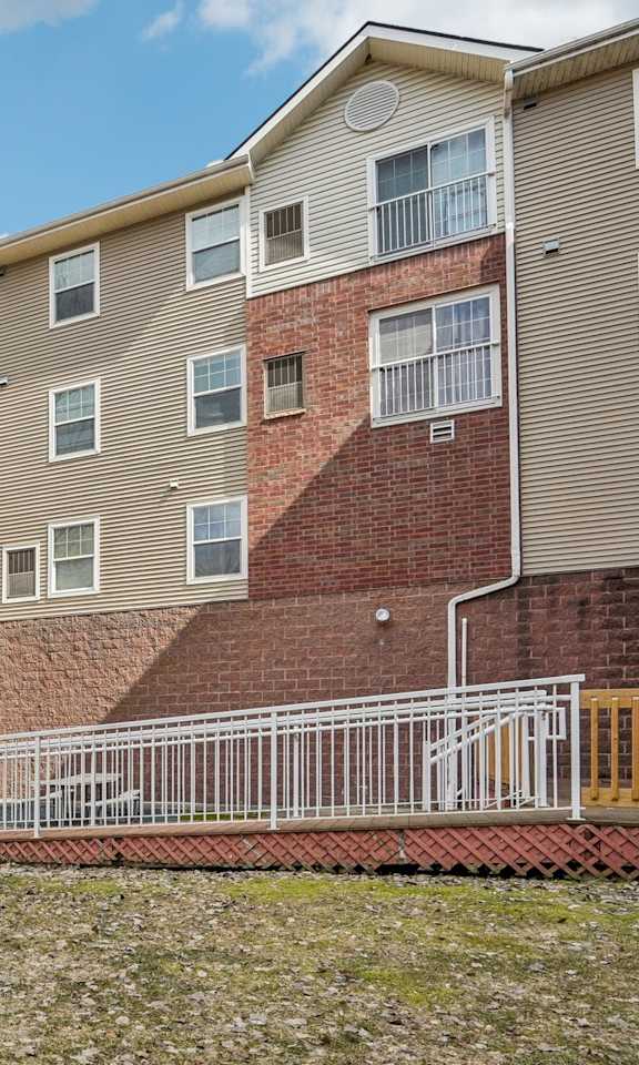 Apartment building with a mailbox in front.