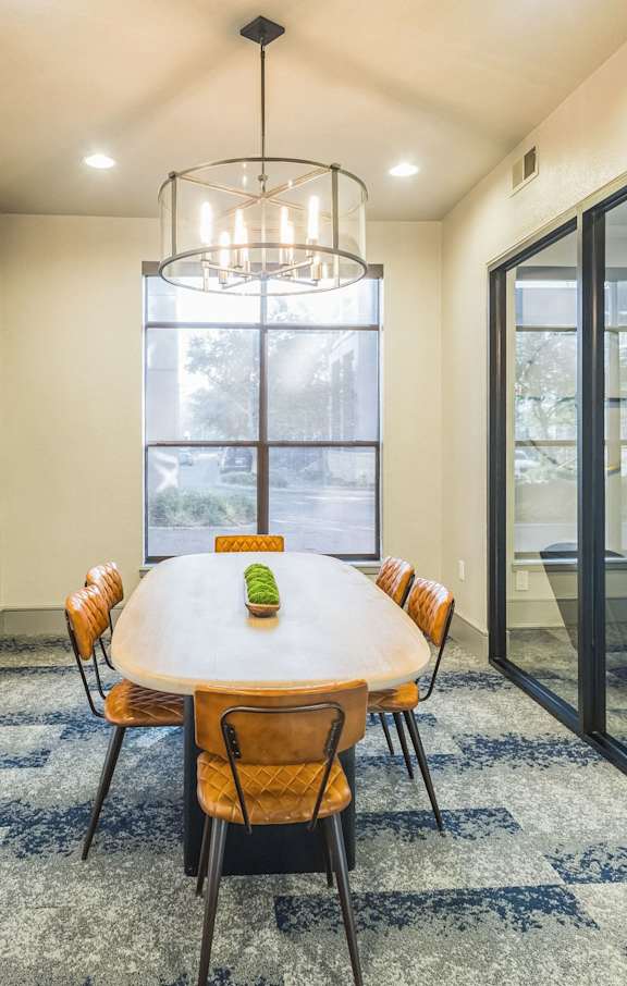 a living room with a staircase and a couch and a trunk at The Atlantic Memorial, Houston, 77079
