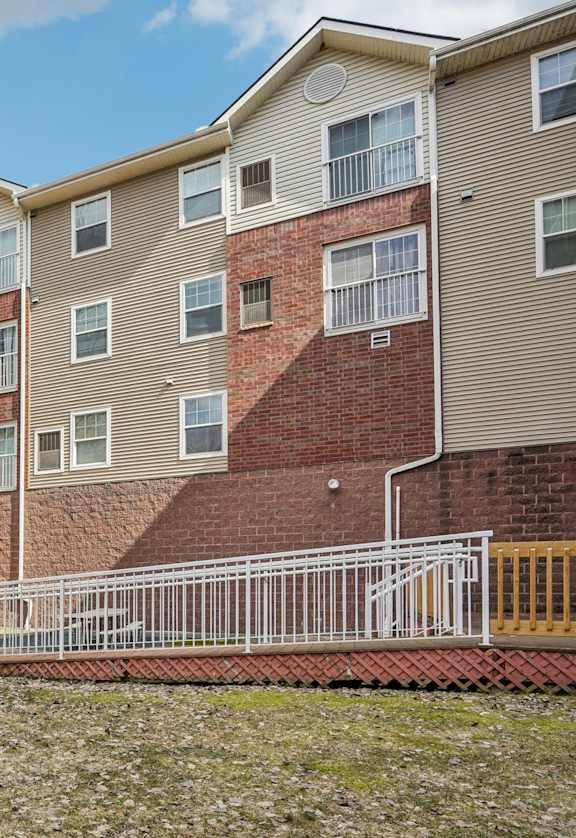 Apartment building with a mailbox in front.