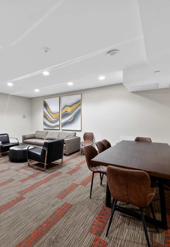 A conference room with a long table and chairs.