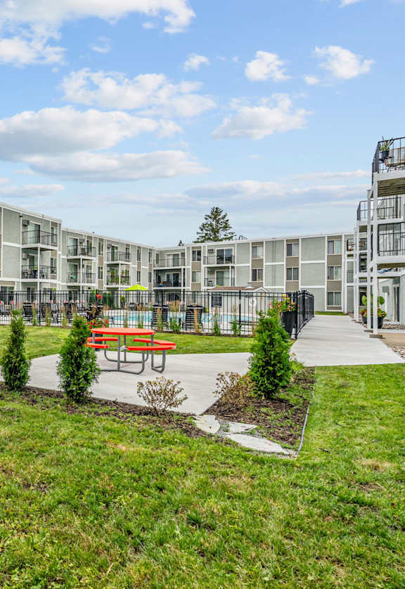 A large grassy area in front of apartment buildings.