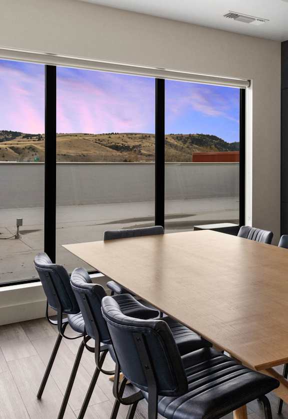 Long wooden dining table and chairs at Cannery Flats, Bozeman,