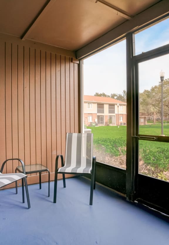 a dining room with a table and chairs and a window